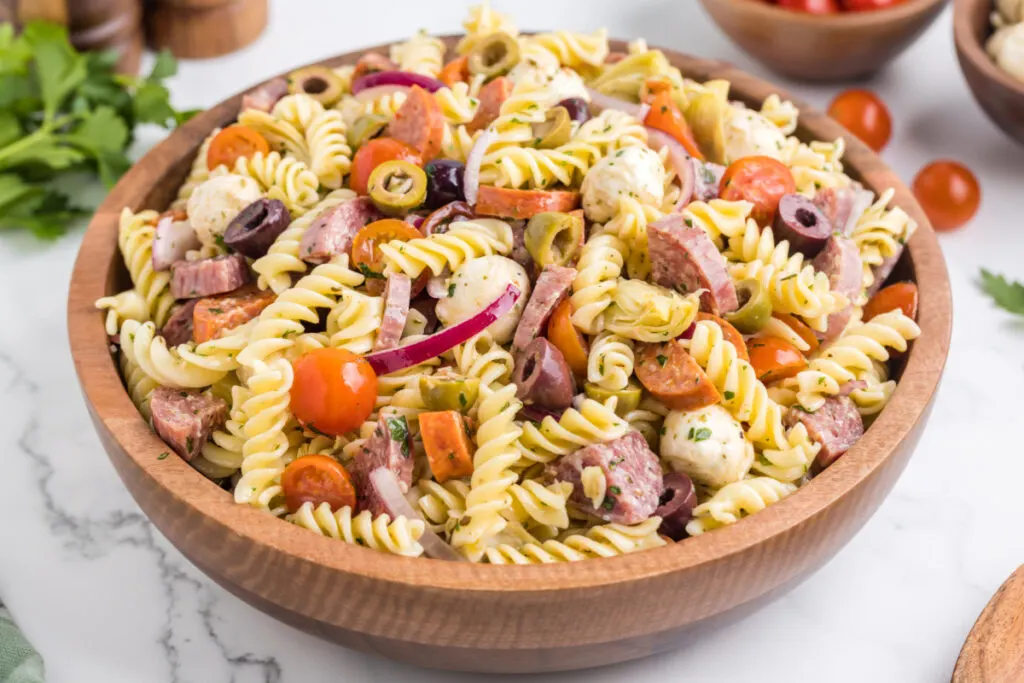 closeup of italian pasta salad in wooden bowl