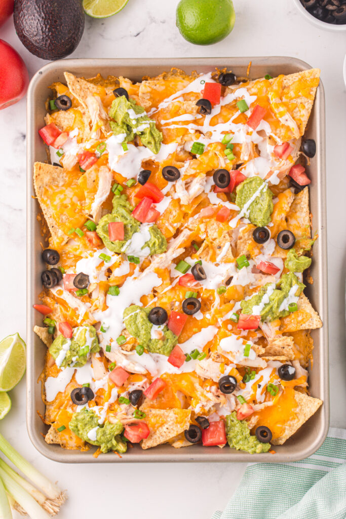 looking down onto a sheet pan of chicken nachos