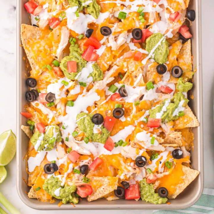 closeup of chicken nachos on sheet pan